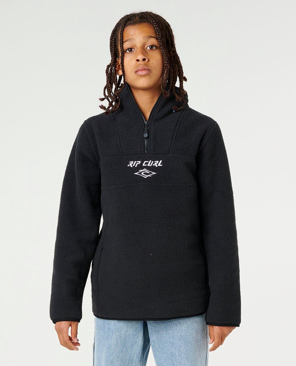 teen wearing Bells polar fleece Ripcurl in black featuring a white ripcurl logo embroidered