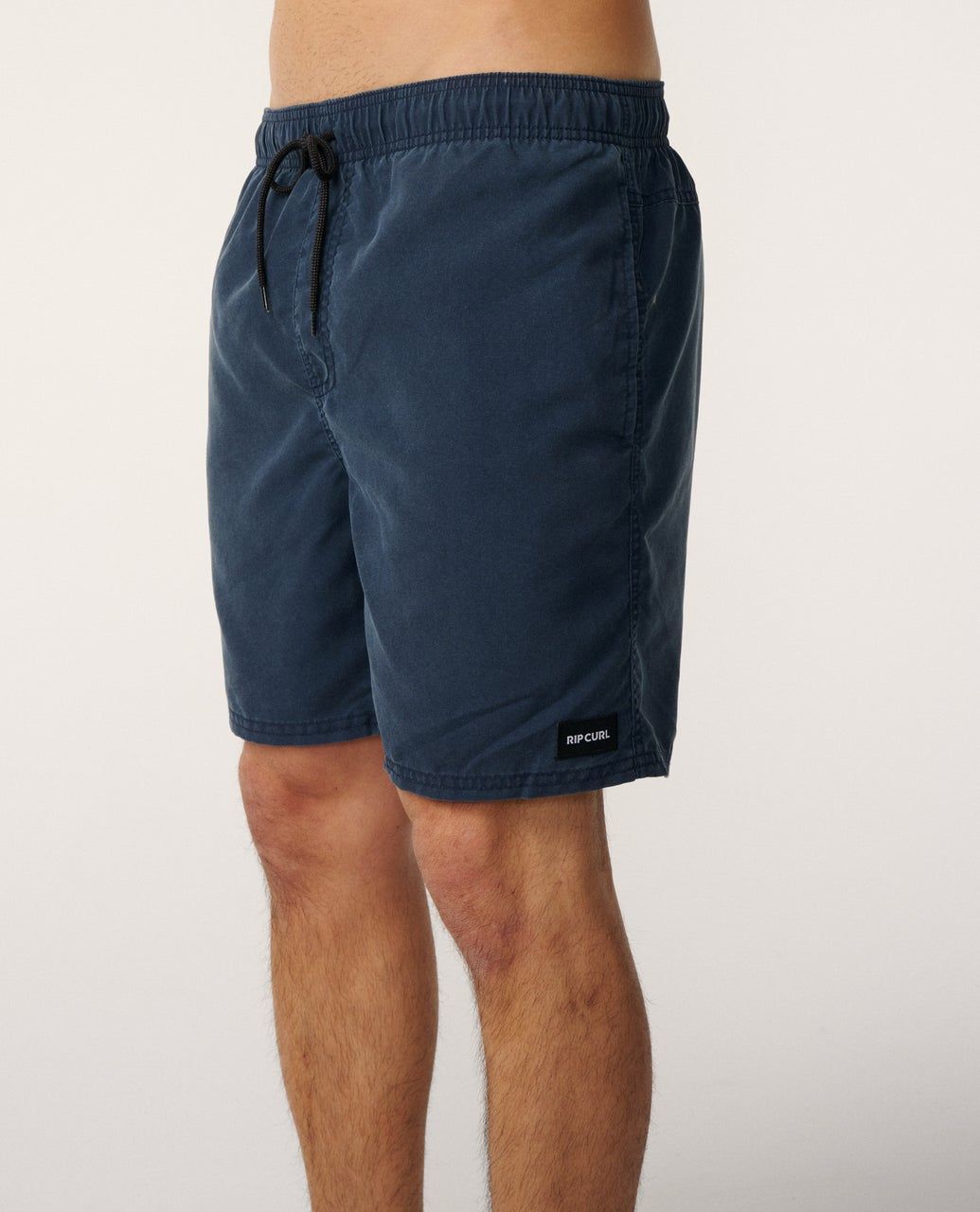 A male model wearing the Rip Curl Bondi Volley Short in Navy, Featuring the navy/blue colour and mid size length.