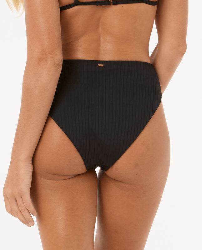 Back view of a female model wearing the RipCurl Premium Surf Retro High Pant in Black featuring a small gold Rip curl logo.