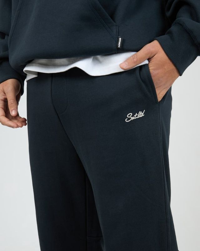 close up of the Radio Sweatpant in Navy showing white st goliath logo and functional pockets