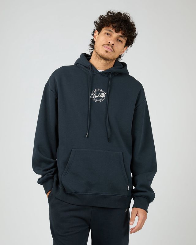 Man wearing the Radio Hoodie by St Goliath in navy featuring a navy colour and white embroidery logo on the chest