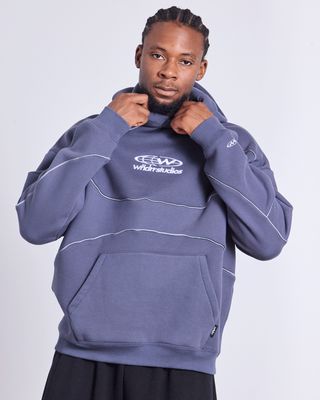 WNDRR GLOBE PANEL HOOD SWEAT in STORM BLUE and grey tubing. Oversized fit wth hood and cuffed sleeves and waistband