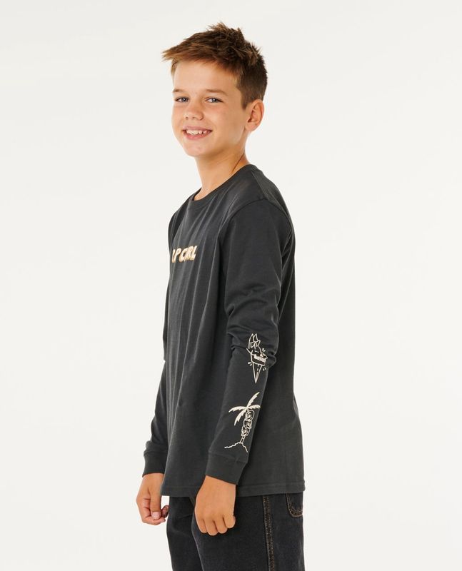 Side view of teen wearing the Eternal long sleeve by ripcurl showcasing the graphics of surf boards,skull and palmtree 