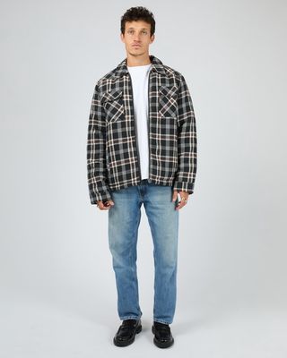 Man wearing the Hamilton check jacket matched back with a white t-shirt and blue jeans 