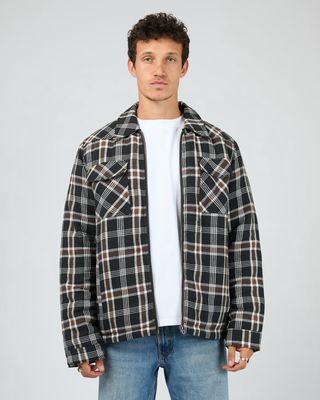 Man wearing th Saint Golaith Hanilton Jacket featuring white, brown and black check pattern