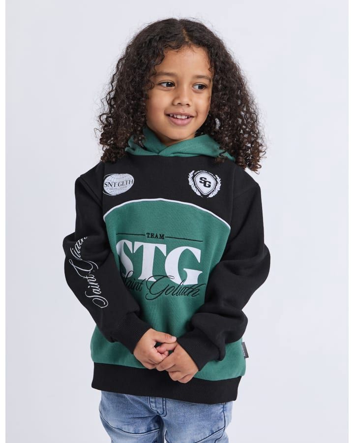 A 3-7 year old model wearing Owners Club Hood, featuring the St Goliath logo and cuffed sleeves 