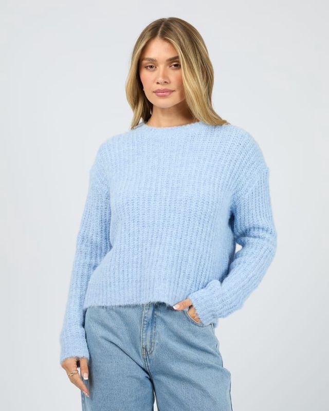 Women wearing the All About Eve Ivy Knit Jumper in ocean blue. Featuring a heavy weight knit with round neckline