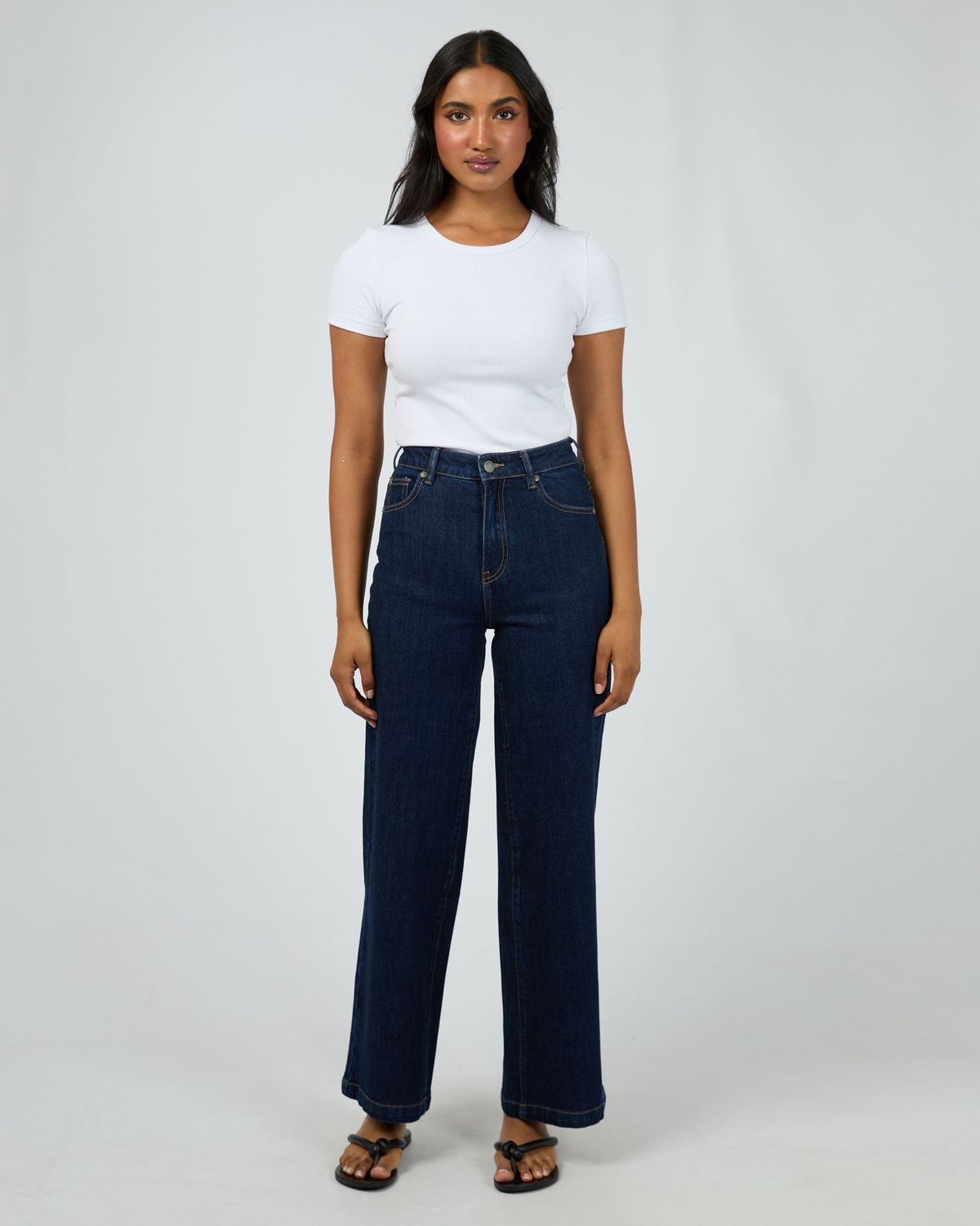 women wearing the All About Eve Jacqui Wide Leg in Indigo. a denim jean in a deep blue colour featuring three front pockets