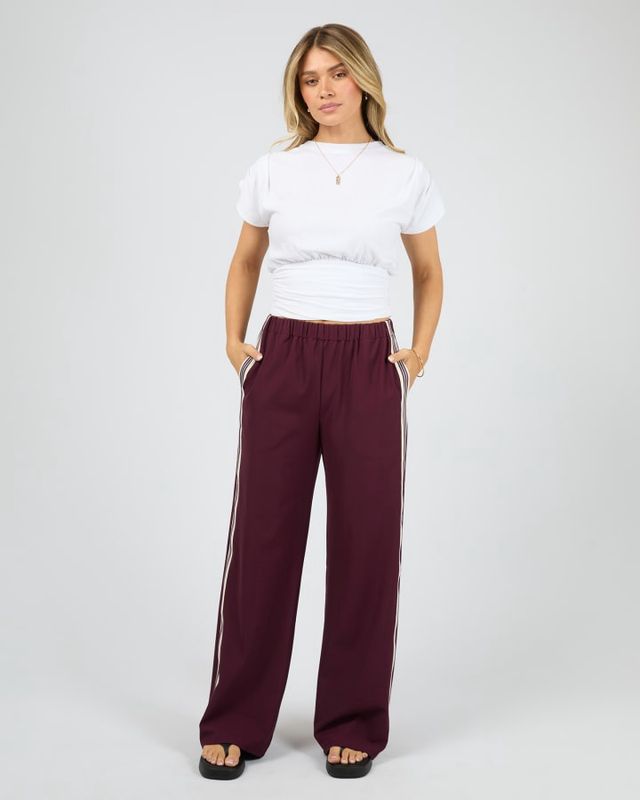 Front view of women wearing the Lina Pant in Wine from All About Eve showing the straight leg fit and the elastic waistband