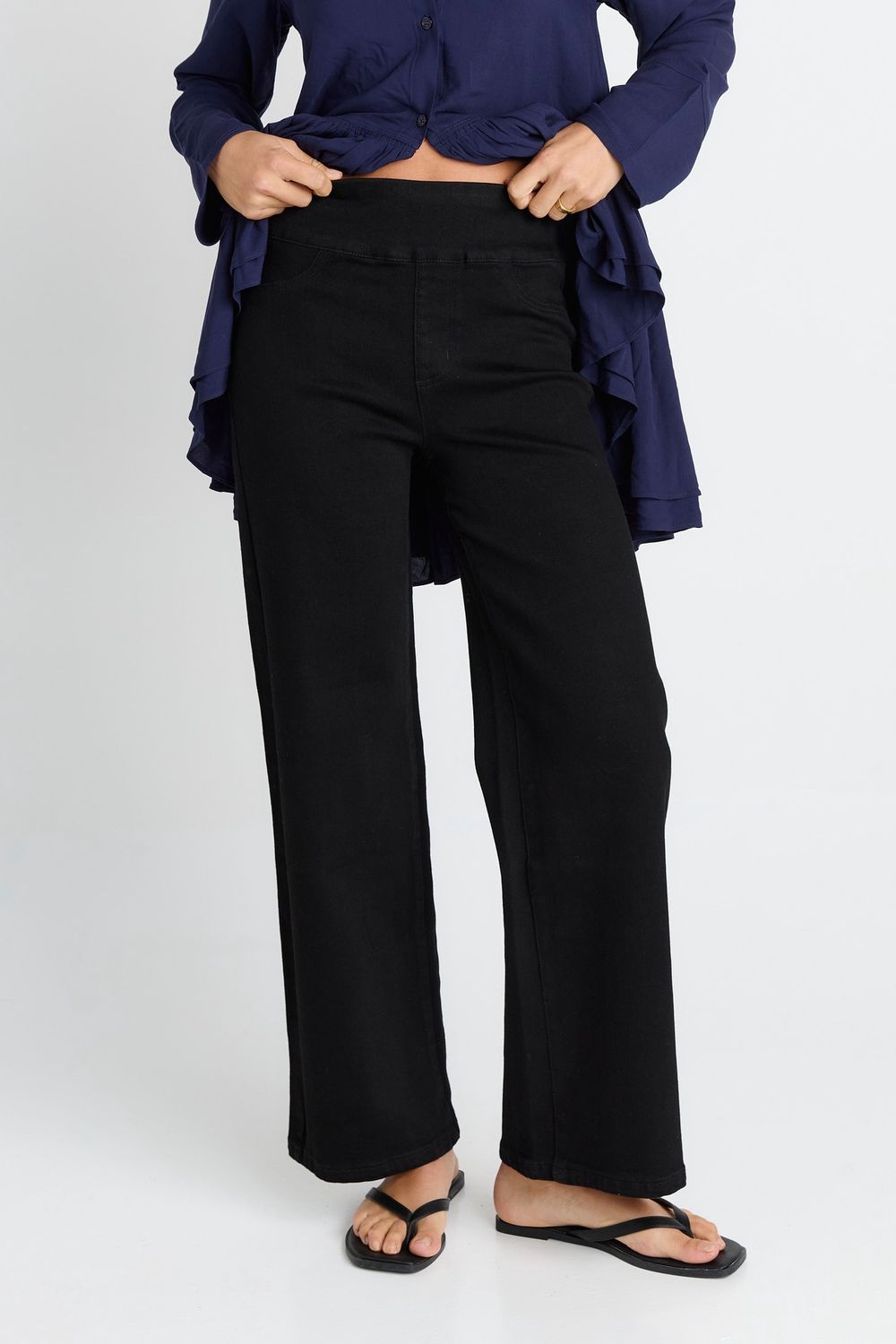 Close up of the Straight Stretch Jean in Black showing the straight legged fit and two nonfunctional pockets for the look