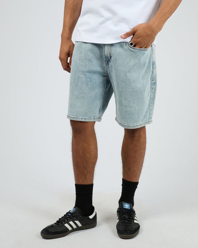 A male model wearing the Shadow A3 Short in Light Blue, featuring 4 functional pockets and mid size length