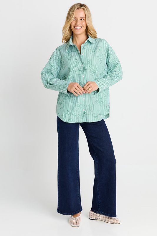A full body view of the Sage Shirt in Green Strip, matching it back with a pair of dark washed jeans for that look.