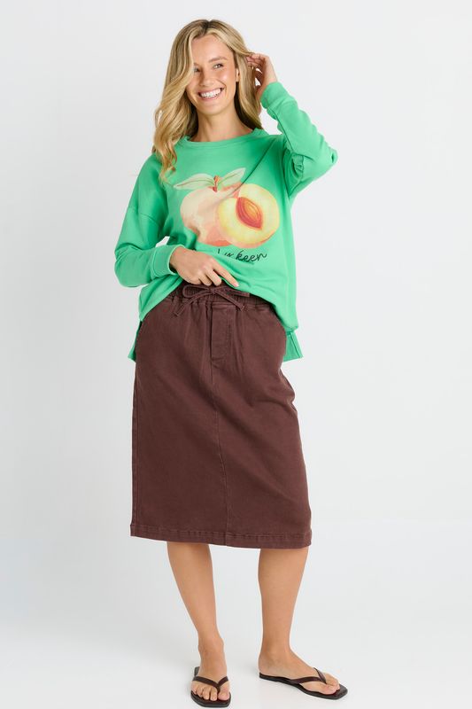 A female model wearing the Quinn Cotton Midi Skirt in Chocolate, Featuring elasticated draw string waist band and midi length