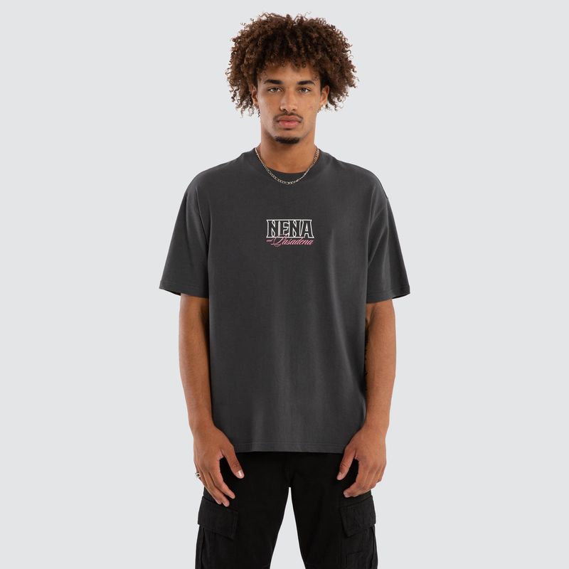 A male model wearing the Maurosa Box Fit Tee, featuring a small NENA logo with pink writing on the front middle.
