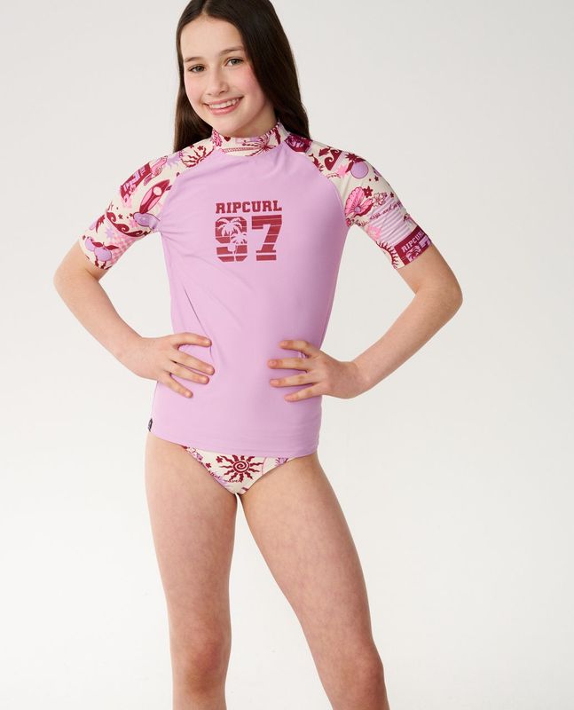 A girl model wearing the Costa Del Sol 3 Piece Set, pairing it with the matching rip curl rashie for a completed look.