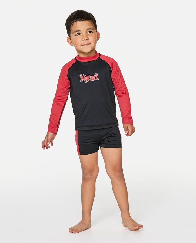  A boy model wearing the Paddle Out Swim Set, matching it back with the Paddle Out Swim short for that completed look.