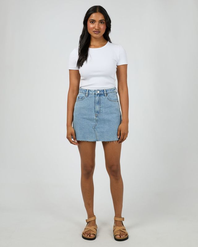 A full body view of the Margot Denim Skirt pairing it plain tee for a simple but sophisticated look.