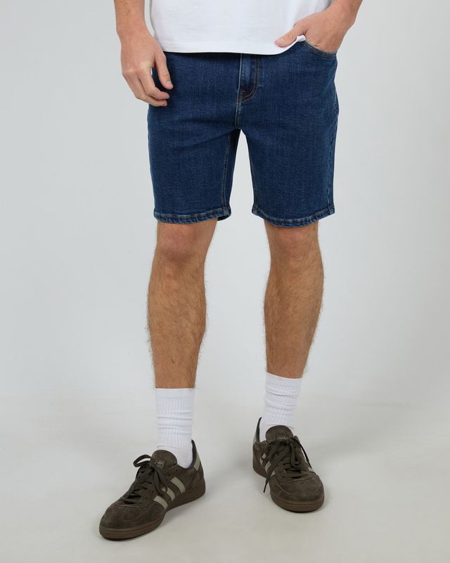 A male model wearing the Shadow A2 Short in Blue, featuring a relaxed fit, and knee-length design for everyday wear.