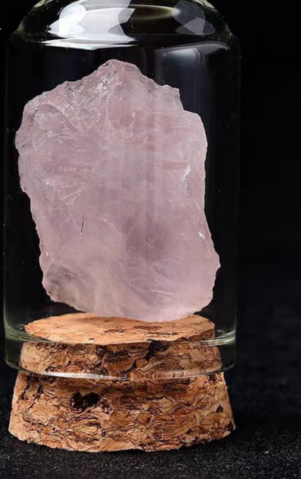 Rose quartz crystal in glass jar