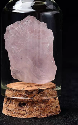 Rose quartz crystal in glass jar