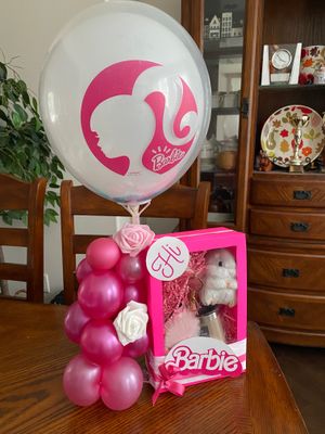 Barbie-themed gift box in pink with pink balloons, Barbie logo balloon, and cute items, ideal for gifting to a little girl who loves Barbie.