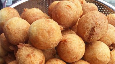 Golden, freshly fried Nigerian Buns, crisp on the outside with a soft, sweet interior—perfect for any occasion or snack.