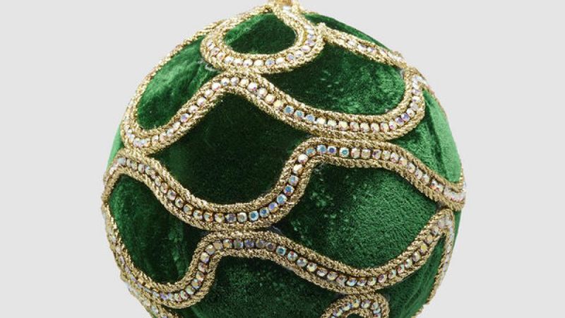 Green Christmas bauble with golden patterns