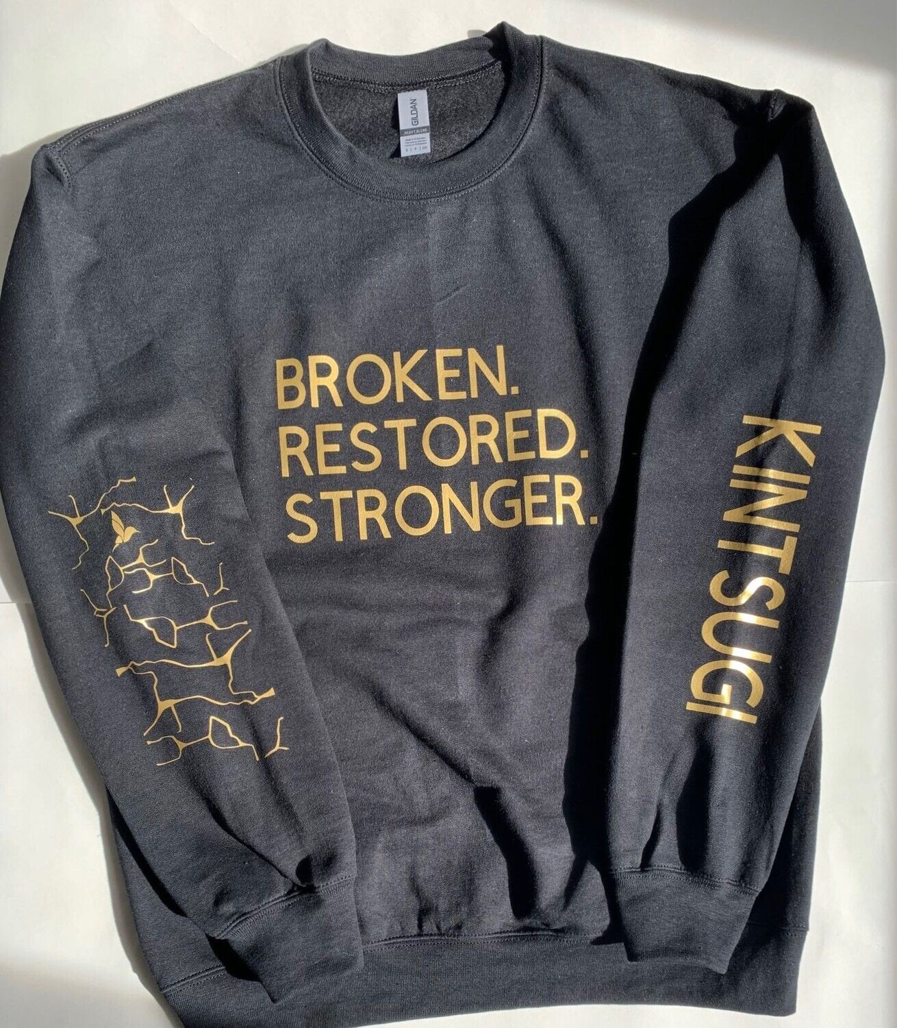 BROKEN.RESTORED.STRONGER. Crewneck
