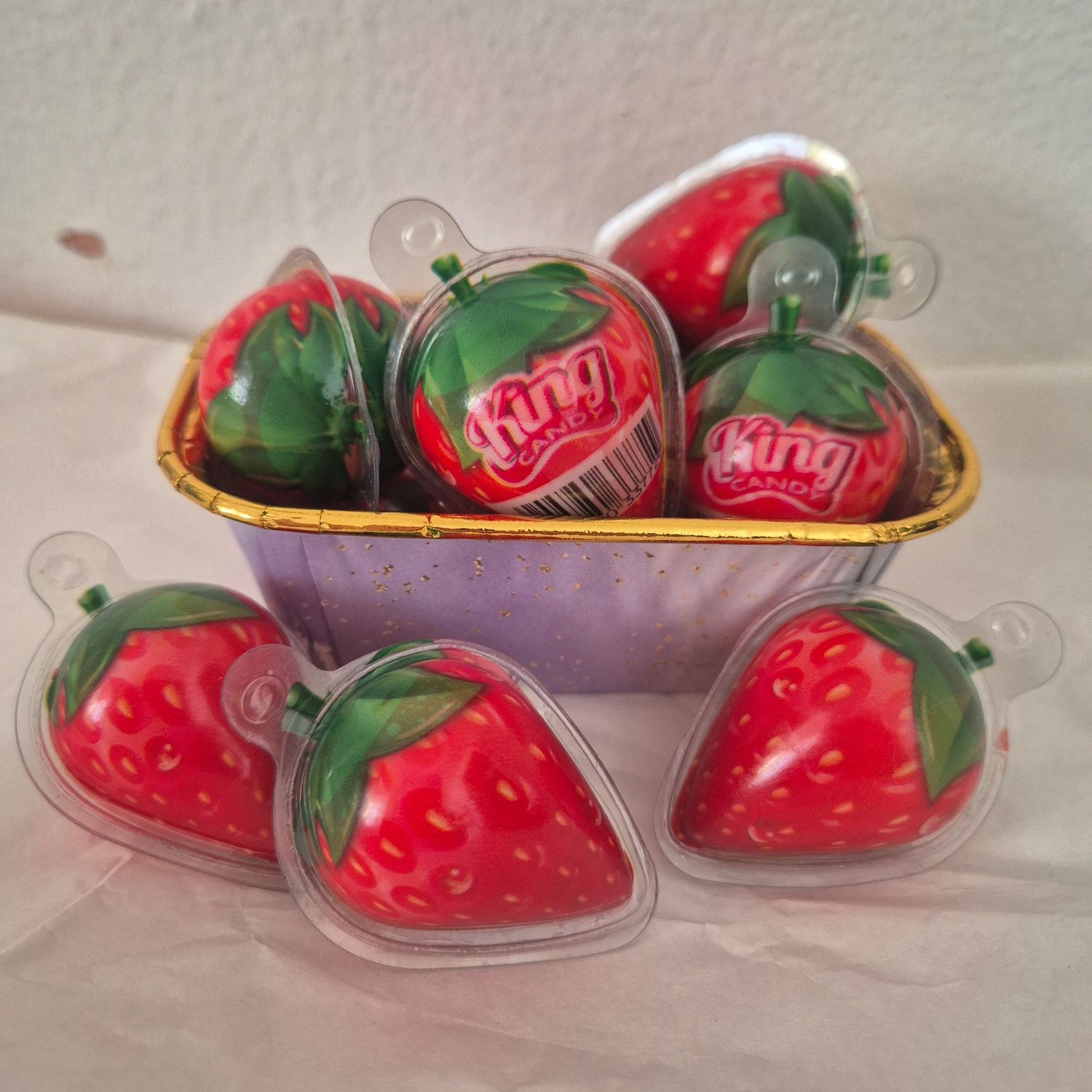 Square gold box with strawberries.