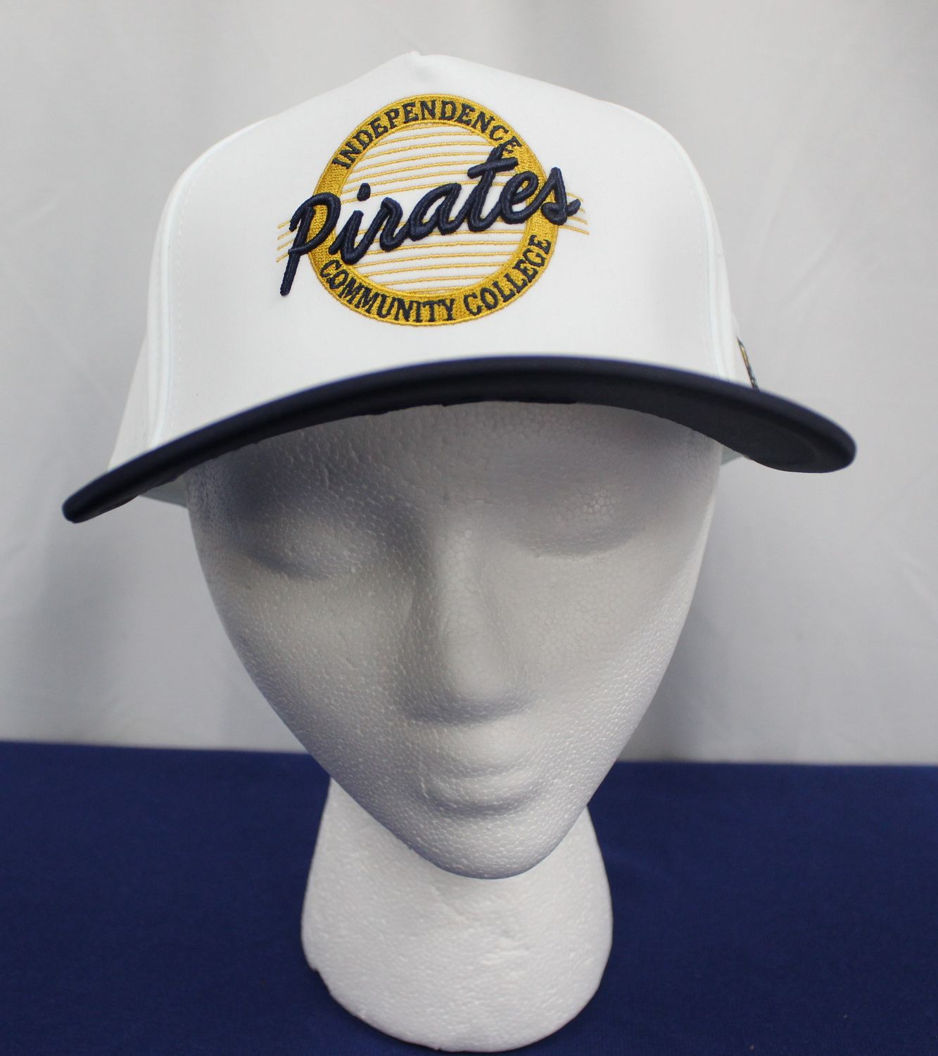 White Neoprene Cap with Navy Bill Pirates Token Logo