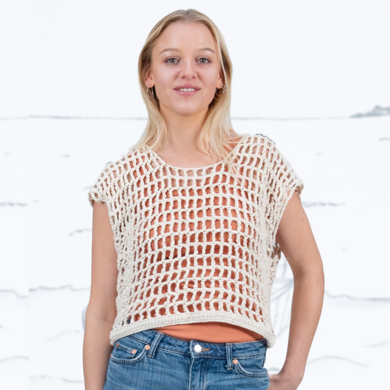 Blond girl wearing Crochet oversized ladies' nettop in a chunky organic cotton. Color: Ivory