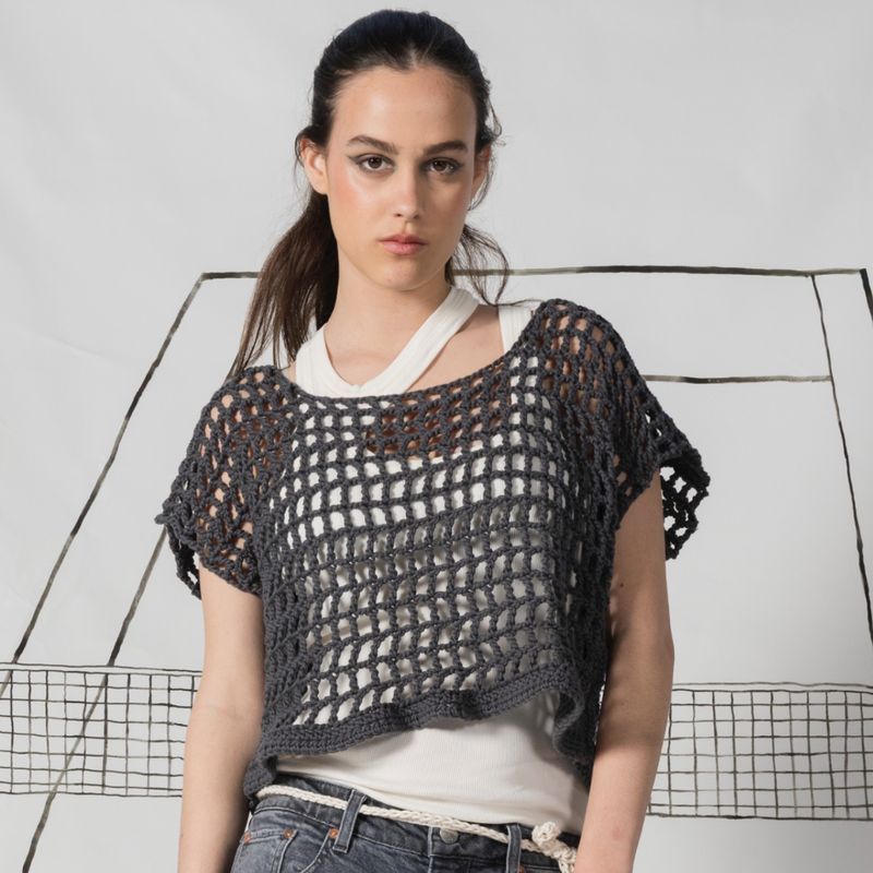 Dark hair girl wearing Crochet oversized  ladies' nettop in a chunky organic cotton. Color: charcoal
