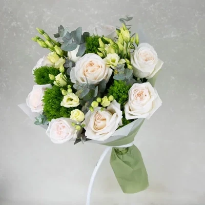A delicate mix bouquet made of different varieties of roses and eustomas.