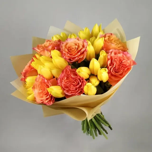 The bouquet is made of orange yellow tulips.
