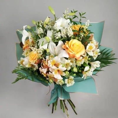 The bouquet is made with seasonal flowers and lilies.