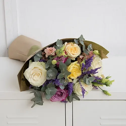 The bouquet is made with seasonal flowers. The approximate size of the bouquet is 60 cm.