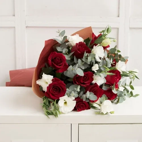 The bouquet is made of red roses and white eustoma.