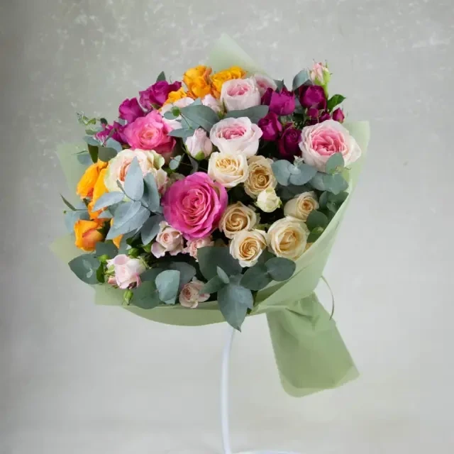 Roses of different colors are used in the rainbow bouquet.