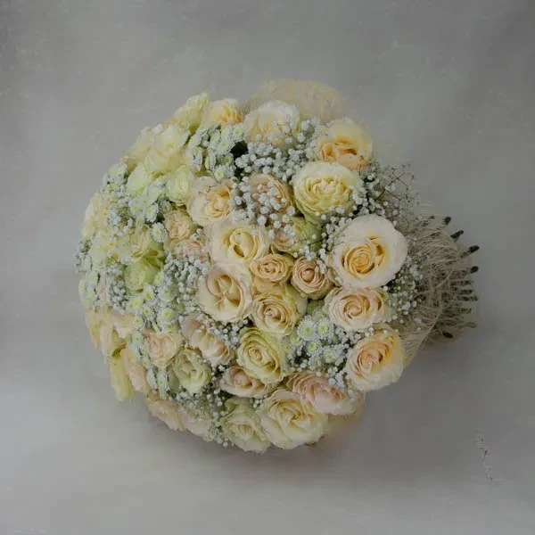 This delicate bouquet is made with cream roses, gypsophila and chrysanthemums &quot;stallion&quot;.