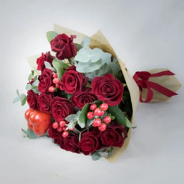 The composition used in the bouquet is made of red roses, decorative hearts and hypericum. The appr…