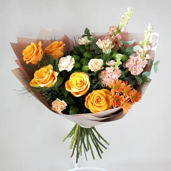 The bouquet is made of orange roses.
