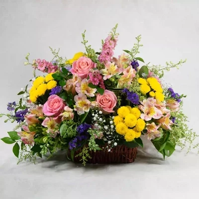 Composition in the basket with mixed flowers