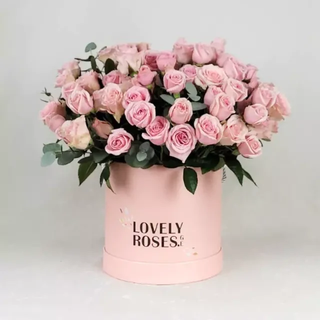 Pink spray roses in a round box