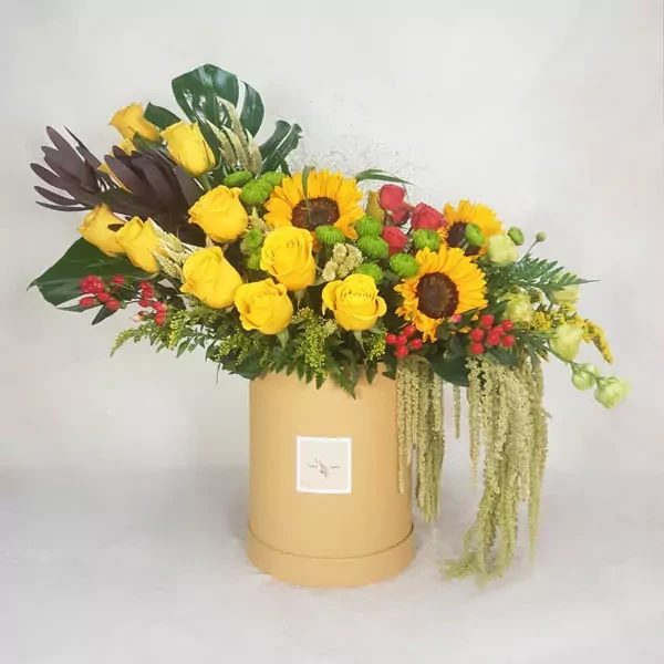 The composition is made with yellow roses, sunflowers, spray roses, chrysanthemum, and hypericum. The approximate size of the composition is 75-60 cm.