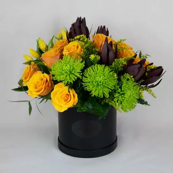 Funeral composition with yellow and green tones in a black box