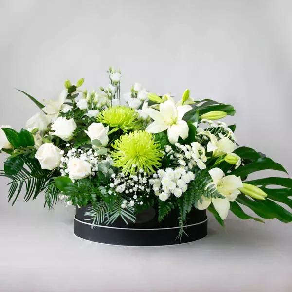 Funeral composition in white-green tones and a black box.
