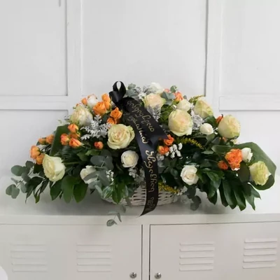 Funeral wreath with white roses and seasonal greenery. The approximate size of the given wreath is 45x50 cm