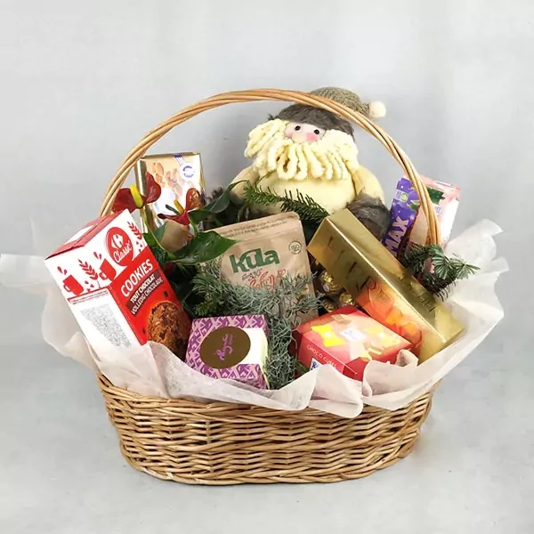 Basket with anthurium, toy and sweets
