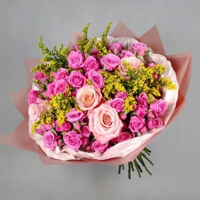 A bouquet of spray roses, solidago, roses