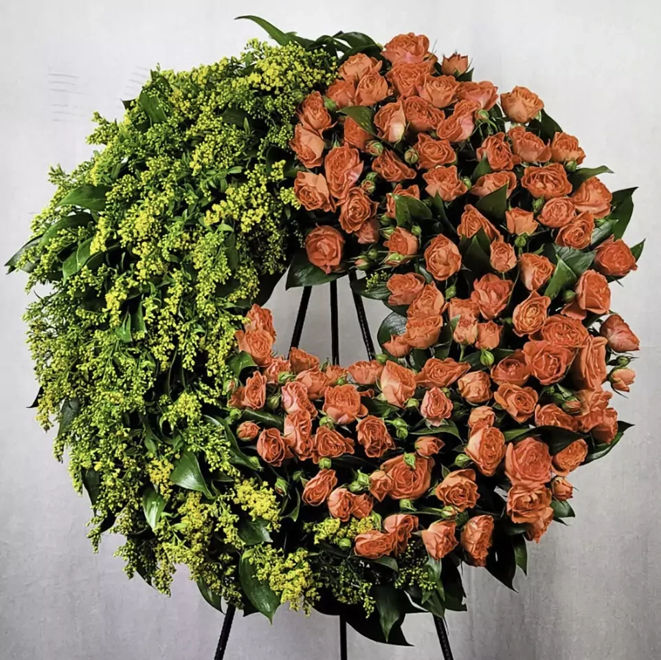 Funeral wreath with spray roses and solidago, on a wooden frame, greenery, made on bioflora, with its own iron stand